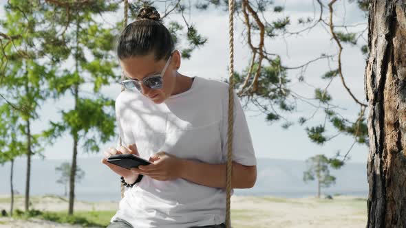 Girl Spending Time on Vacation with Mobile Gadgets