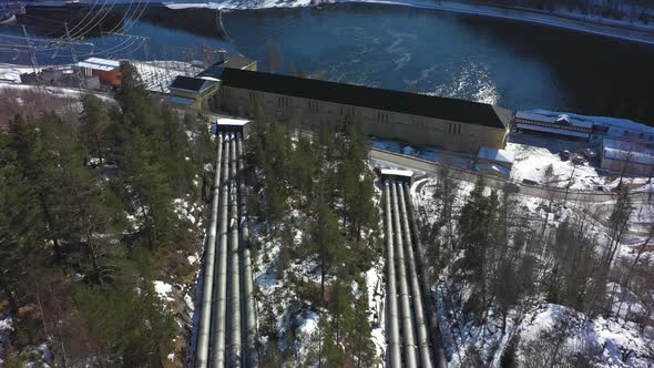 Huge water pipelines leading to Nore I hydroelectric powerplant in Rodberg Norway - Aerial flying ab