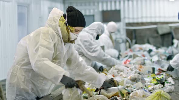 Workers in Protective Suits Sorting Plastic Waste