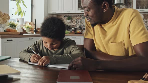Boy Doing Homework with Father
