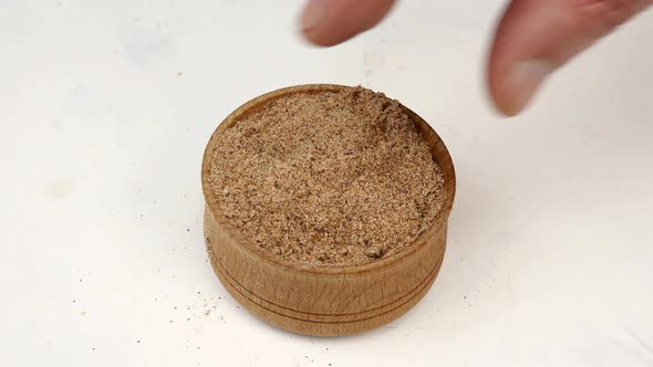 Chef Taking Chopped Dry Nutmeg Powder Spices From Wooden Spice Jar