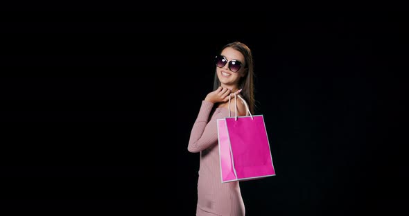A Girl Holding a Pink Shopping Bag During a Shopping Trip
