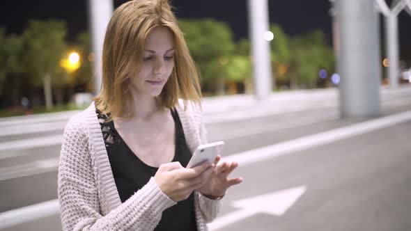 Young Pretty Redhaired Woman Using Her Smatphone