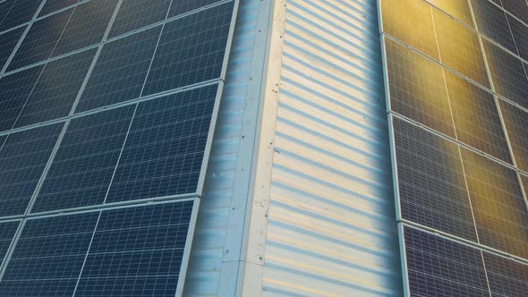 Blue Photovoltaic Solar Panels Mounted on Building Roof for Producing Clean Ecological Electricity