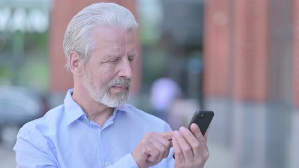 Outdoor Old Man Using Smartphone