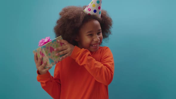 Smiling African American girl receives birthday gift