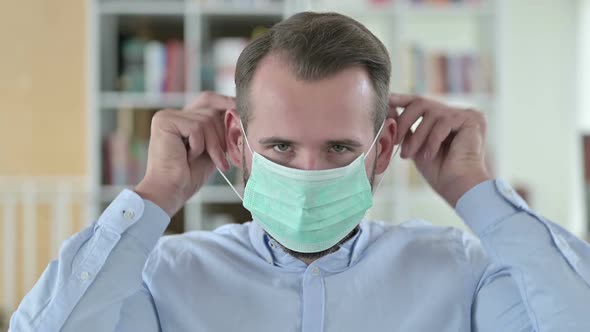 Portrait of Young Man Demonstrating Wearing Mask