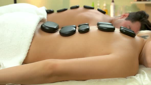 Woman Relaxing Getting Hot Stone Massage