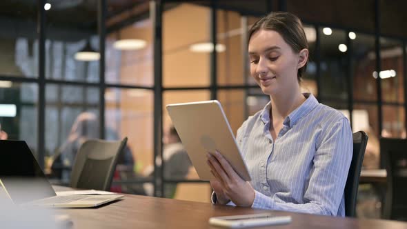 Young Woman Using Digital Tablet at Work