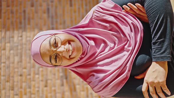 Indoor Vertical Video of Young Muslim Woman Wearing Pink Hijab and Glasses