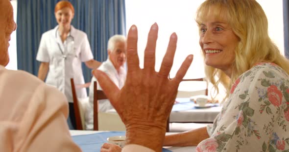 Senior woman talking to each other while female doctor walking towards them