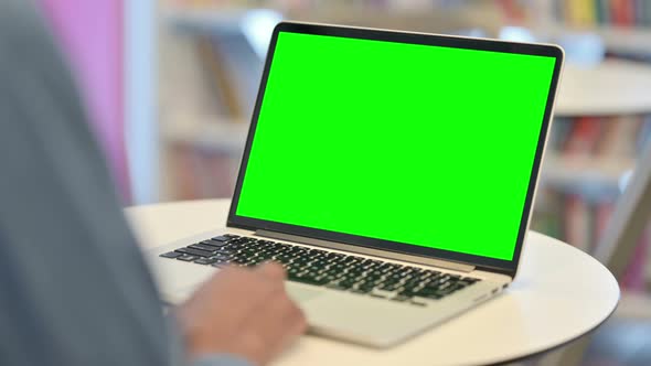 Man Using Laptop with Green Chroma Key Screen Rear View