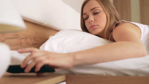 Woman Waking Up and Looking at Phone.