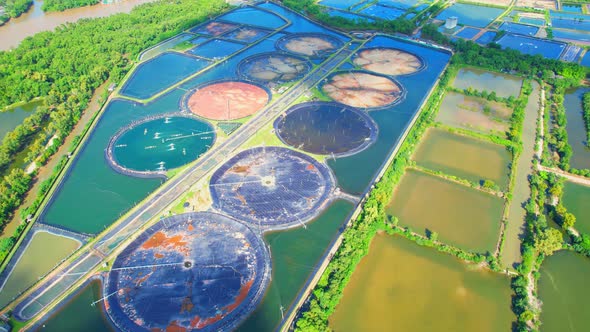 An aerial view of a drone flying over a large shrimp farm