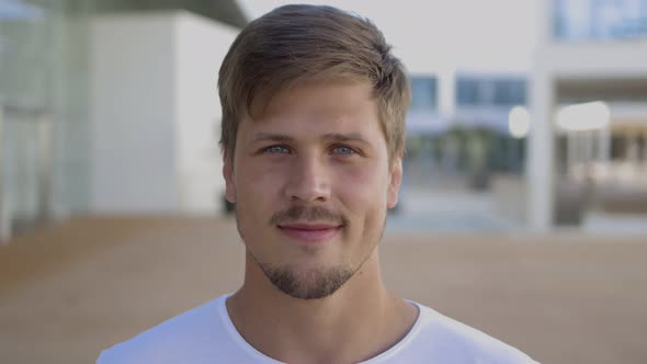 Closeup Shot of Handsome Smiling Young Man Looking at Camera