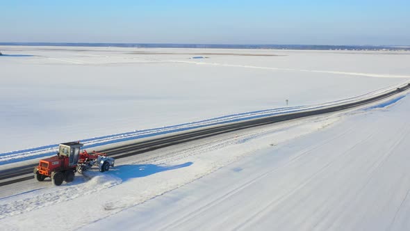 Aerial View Snow Removal Tractor Clears Road From Snow