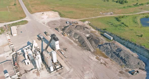 Arial view of the open pit mine gravel into stone crusher in heavy mining machinery
