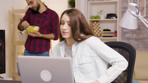 Girl Enjoying a Cup of Coffee While Working on Laptop in Living Room