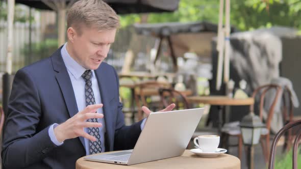 Angry Businessman Working on Laptop in Frustration