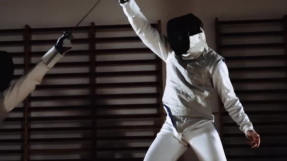 Men In Fencing Masks Thrusting With Foils In Duel