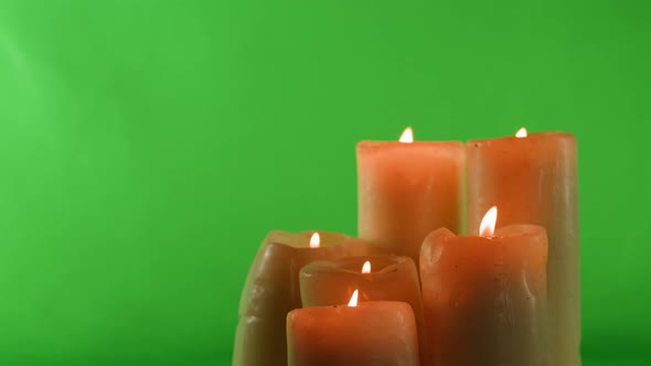 Burning Wax Candles on Green Chroma Key Background