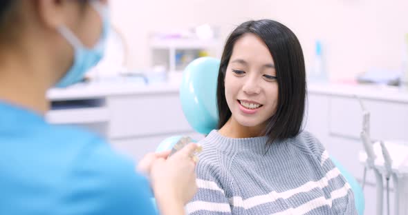 Woman undergo consultation with dentist at dental clinic