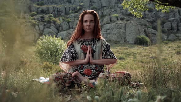 Beautiful and Healthy Ginger Woman Breathing Gently and Sits in Pose of Lotus