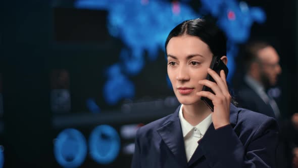 Focused Successful Asian Woman in Suit Calling Mobile Phone at Trade Marketing