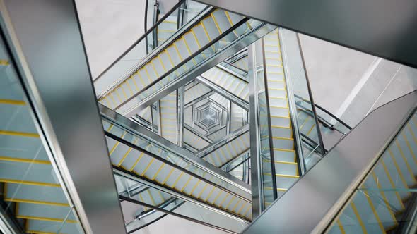 Puzzling labyrinth of escalators made of glass and steel. Complicated passages.