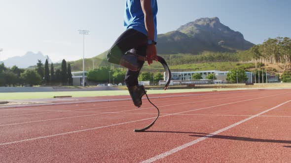 Disabled mixed race man with prosthetic legs stretching