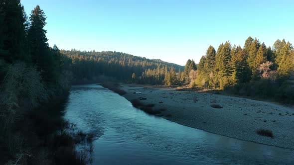 Water Flowing In Smith River With Coniferous Forest In Summer In Humboldt County, California, USA. -