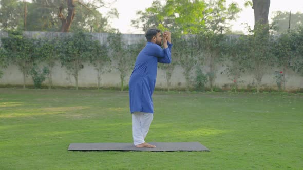 Indian man doing basic yoga pose