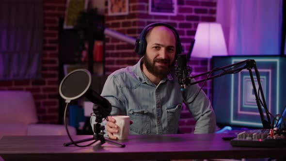 Portrait of Online Radio Host Posing Casual Using Professional Audio Equipment and Microphone