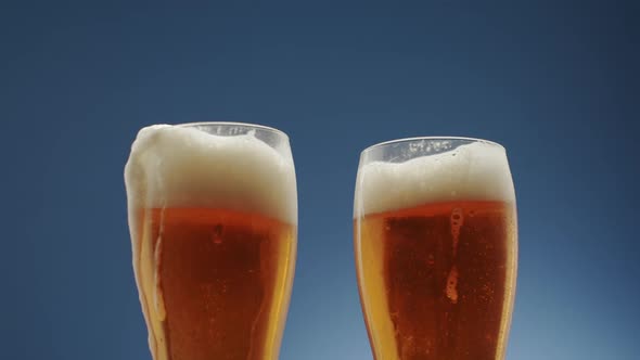 Two Glasses Full of Frothy Beer