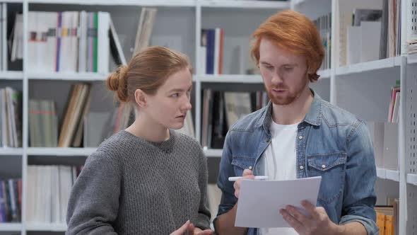 Creative Teammates Busy Doing Paperwork in Office Discussing Project