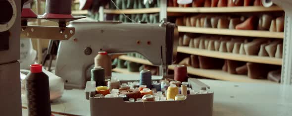 Sewing Machine and Spools of Thread in Workshop