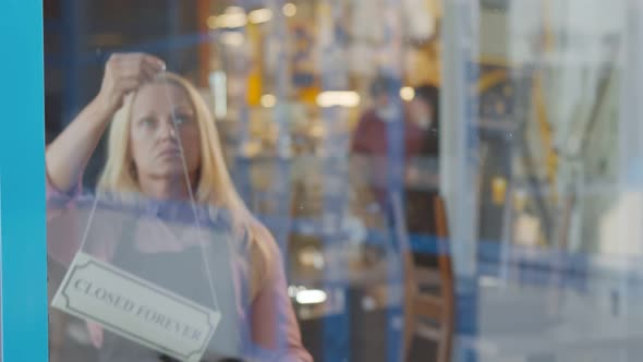 Senior Woman Business Owner Bankrupt Hanging Up Sign with Inscription Closed Forever