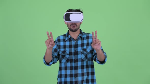 Happy Young Bearded Persian Hipster Man Using Virtual Reality Headset