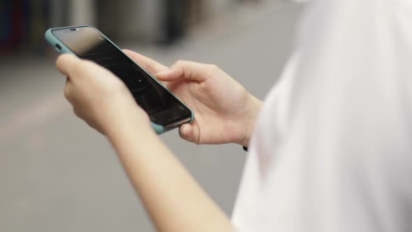 Close up hands using smartphone checking social media communication and shopping online.