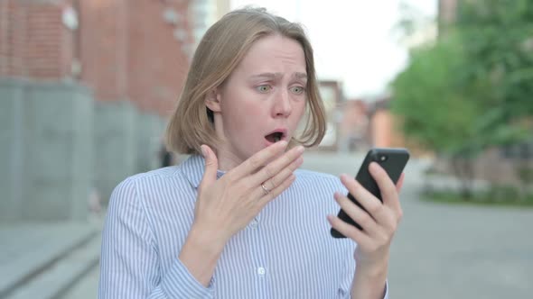 Portrait of Woman Having Loss While Using Smartphone