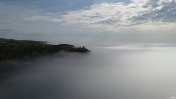 Split rock light house during a foggy sunny morning, aerial footage