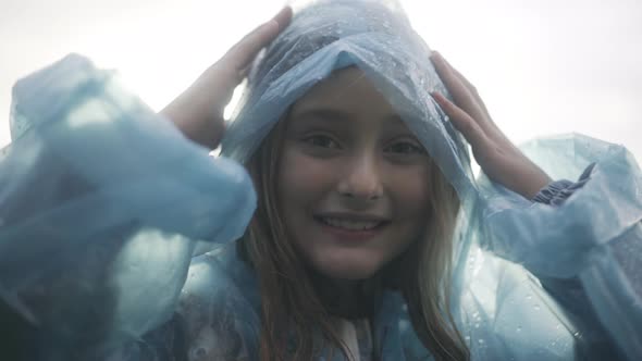 Closeup of Beautiful Girl in Raincoat Posing in Sunlight Outdoors