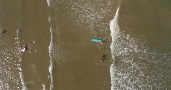 Birds eye view of surfers in the Gulf of Mexico off the coast of Lake Jackson in Texas