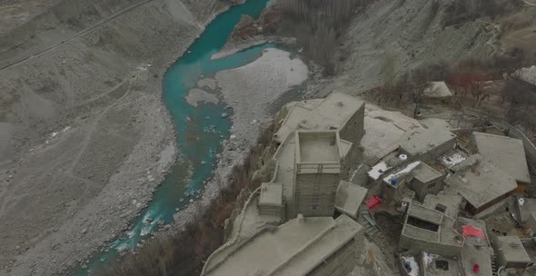 Aerial Over Rooftops Of Remote Village In Hunza Valley Beside River. Circle Dolly