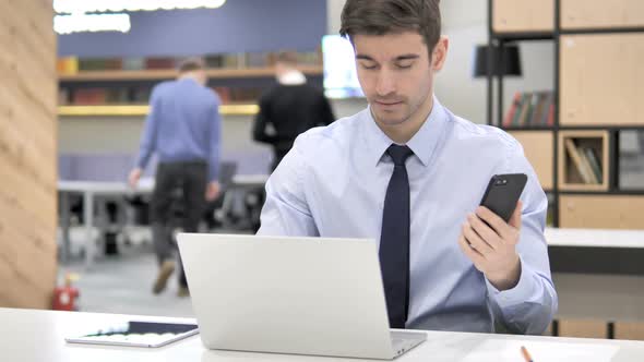 Businessman at Work Using Smartphone