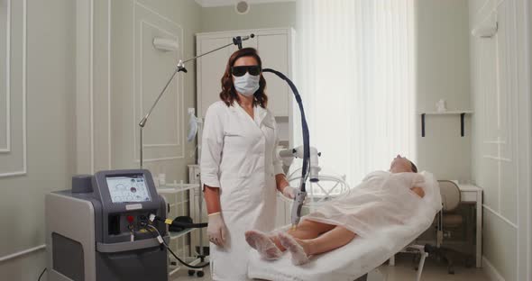 A Dermatologist Ready for Procedure of Treating Patient's Skin with a Laser