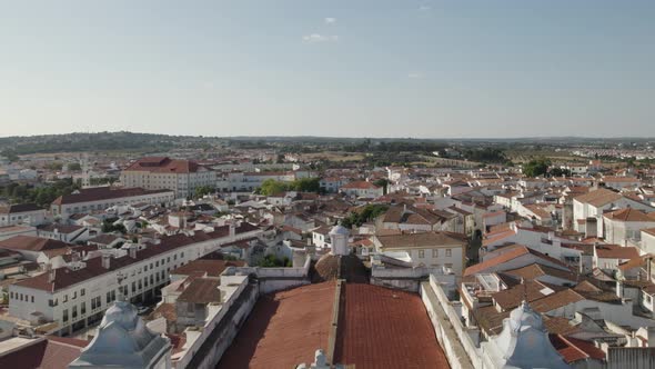 Stunning aerial backward view along rooftop of Saint Andrew or Santo Antao Church, Evora