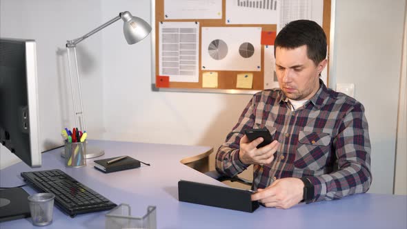 Young Businessman Work in His Office Using His Tablet