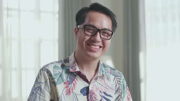 Close Up Of Asian Man Smiling To Camera While Cook Healthy Food At Home