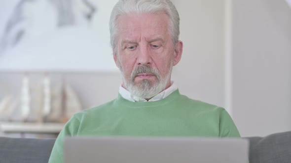 Close Up of Old Man Working on Laptop